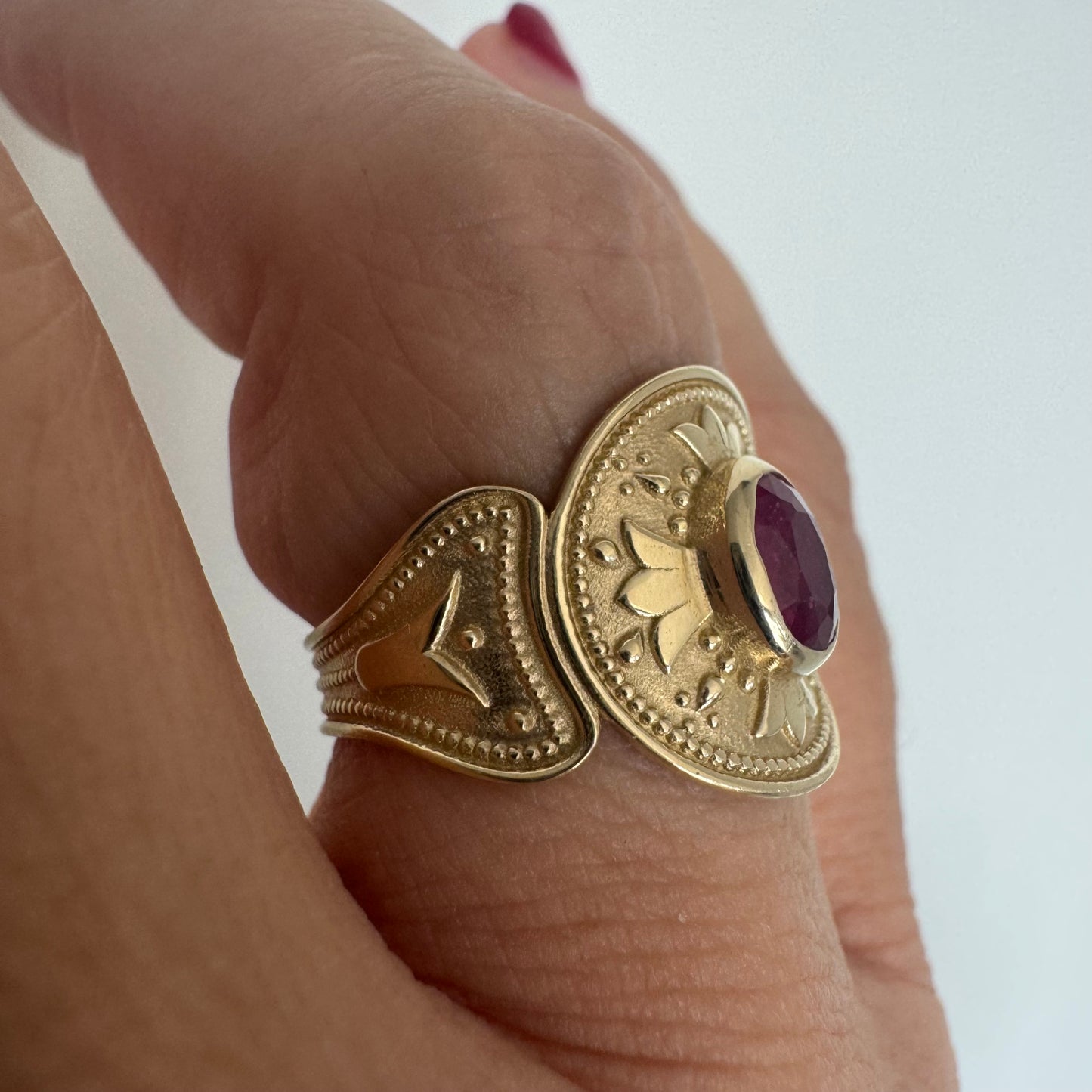 14K gold ring set with an oval Ruby