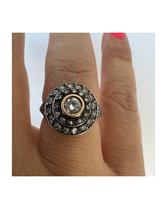 18K gold ring set with Diamonds in an intricate circular design.