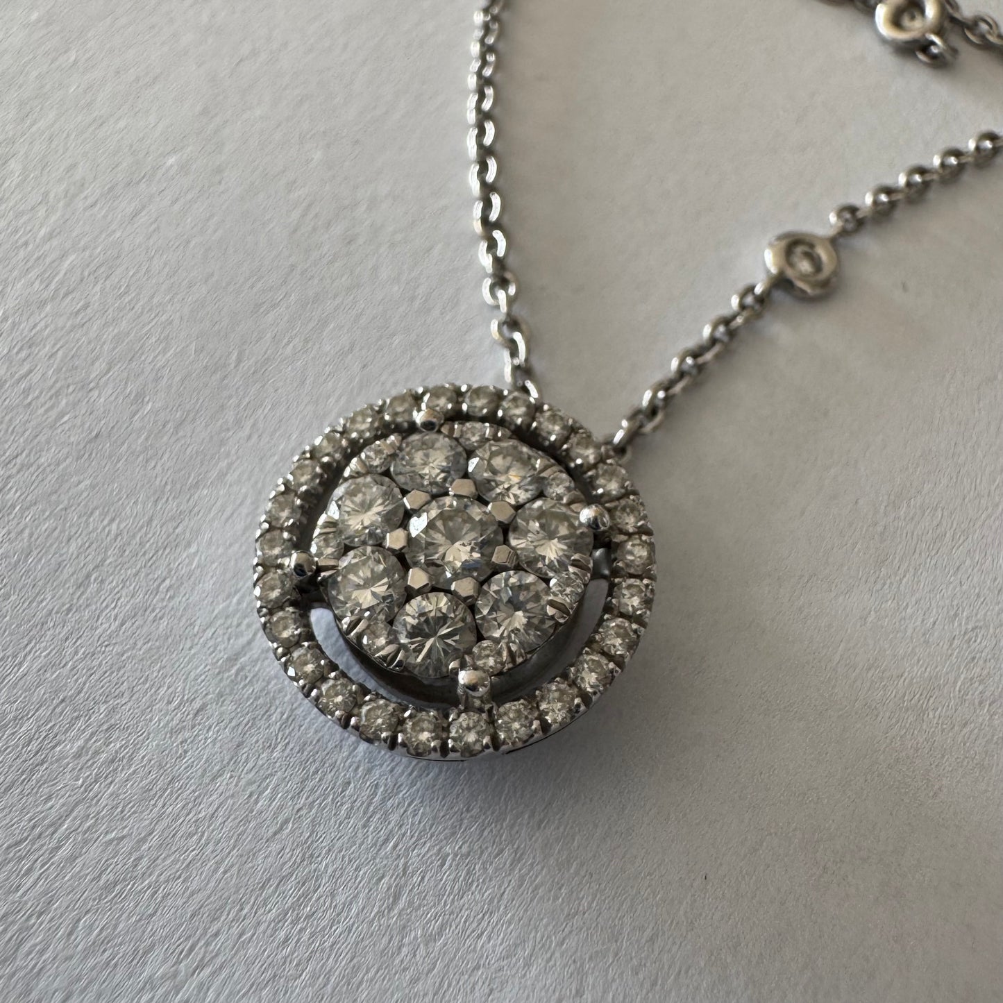 14K gold necklace featuring a round pendant set with a cluster of sparkling Diamonds