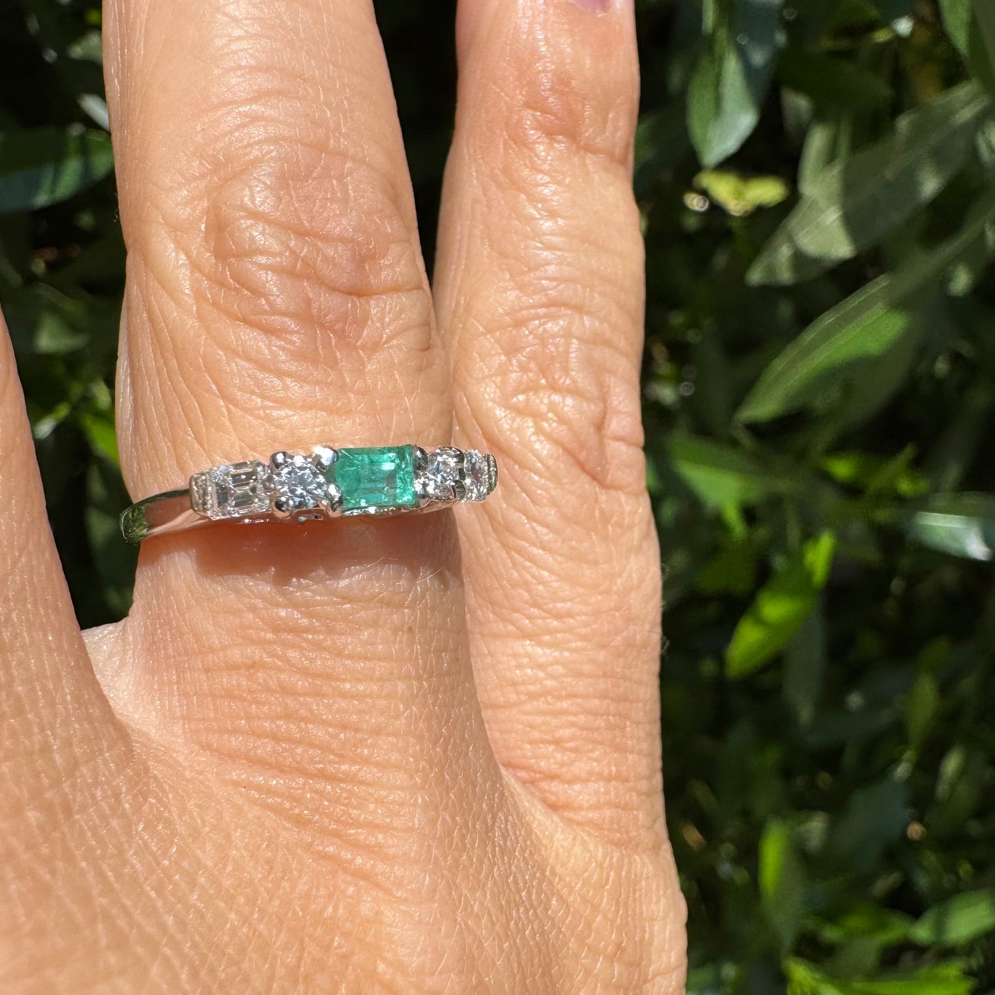 14K gold ring set with one center Emerald & Diamonds on the sides
