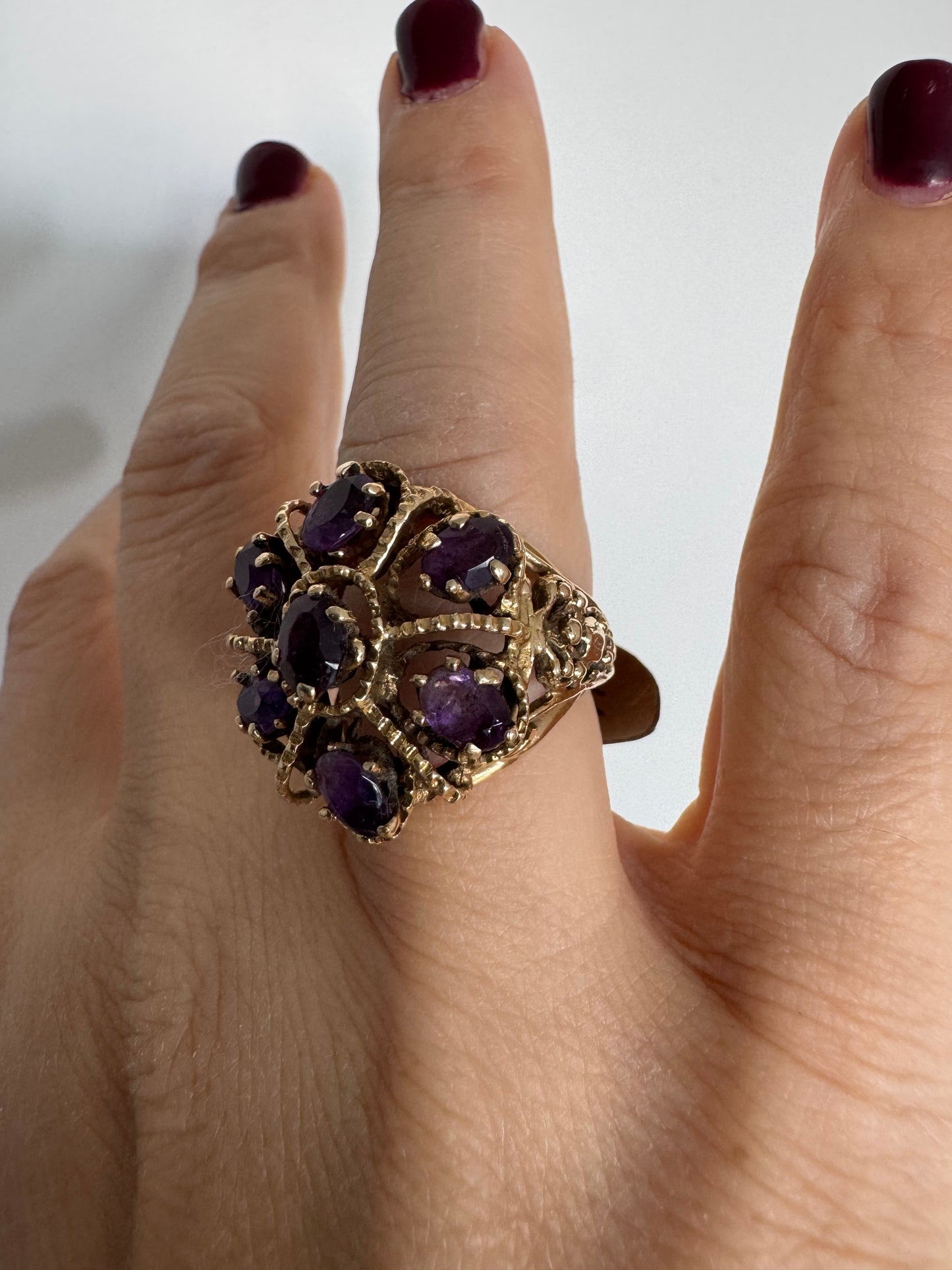 14K yellow gold cocktail ring set with a stunning cluster of Amethyst stones in marquise cuts.
