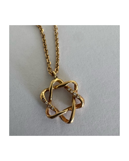 14K gold “Star of David” pendant with a sculptural open design.