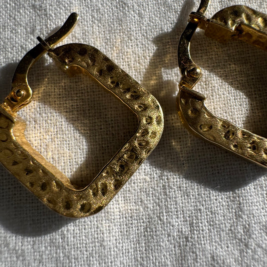 14K gold square hoop earrings with a textured, hammered finish.