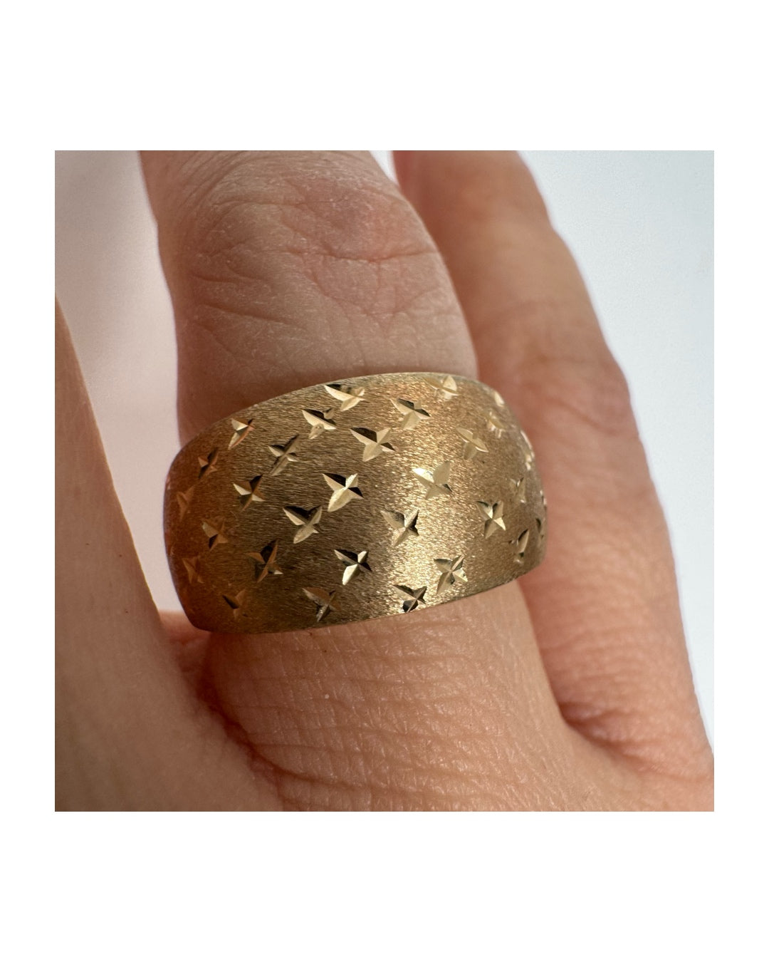 14K gold wide signet-style ring with a matte finish and delicate star engravings.