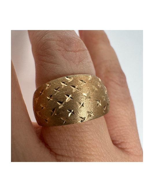 14K gold wide signet-style ring with a matte finish and delicate star engravings.
