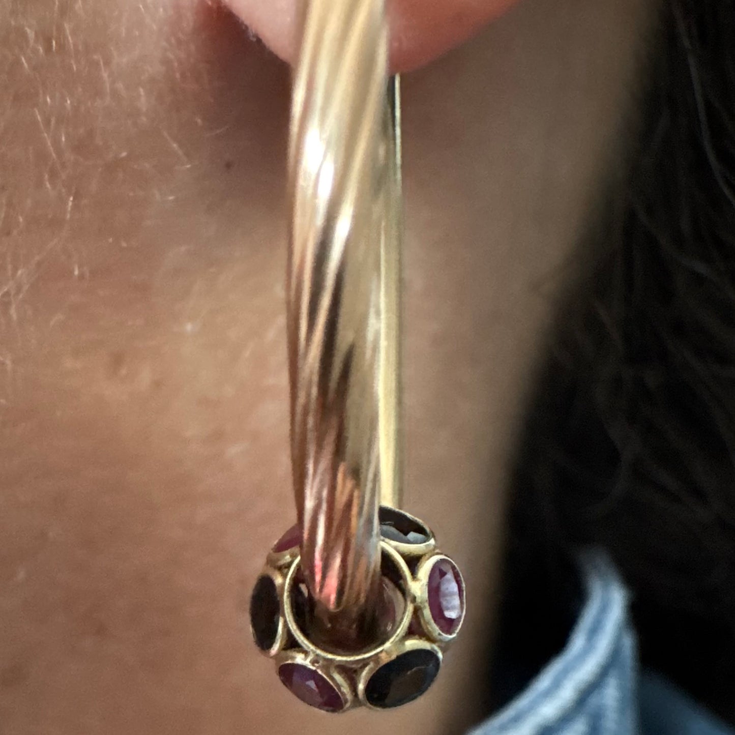 10K gold hoop earrings with a twisted design, set with pink and green Tourmaline.