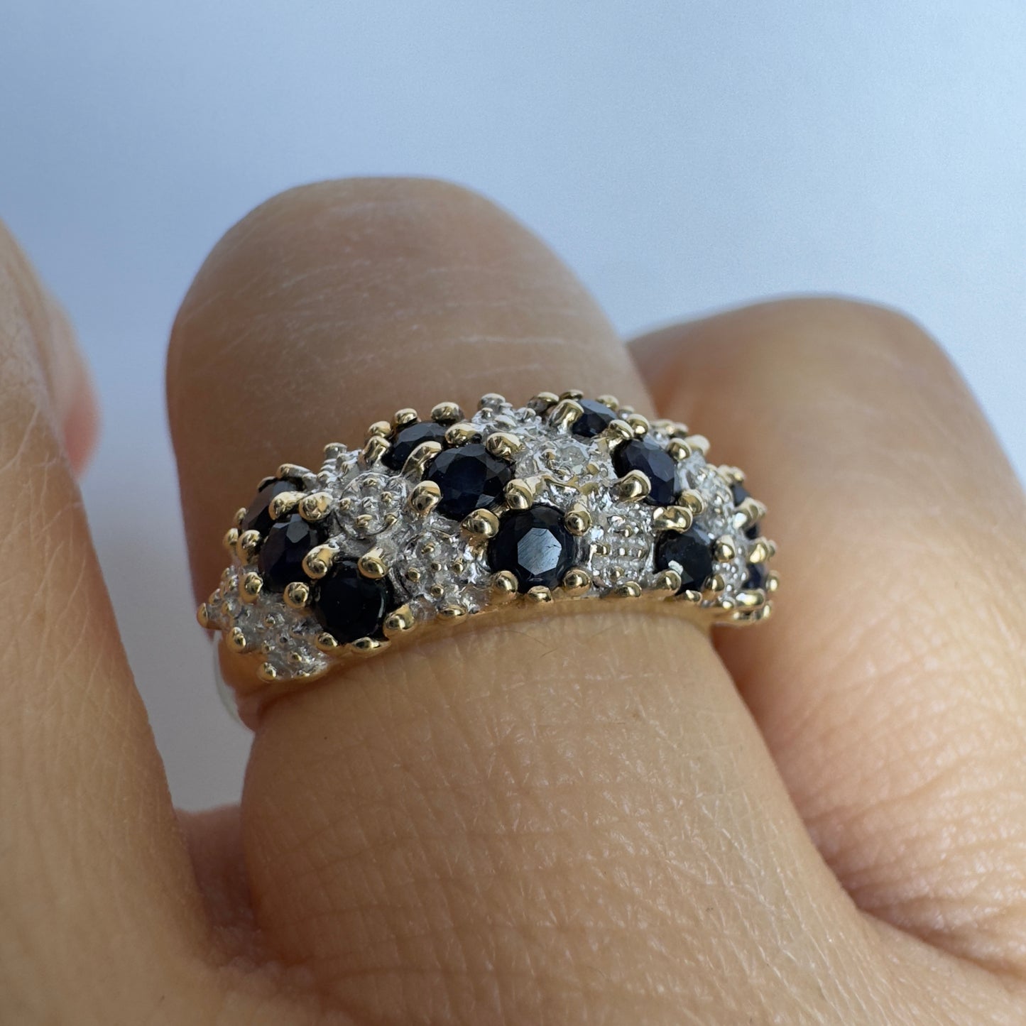 10K gold ring set with deep blue Sapphires and Diamonds in a classic, romantic design.