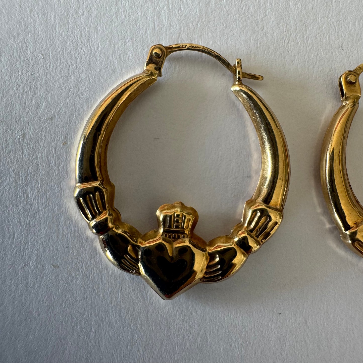 9K gold Claddagh earrings, featuring the iconic Irish motif of a heart held by two hands and topped with a crown, traditionally symbolizing love, friendship and loyalty.