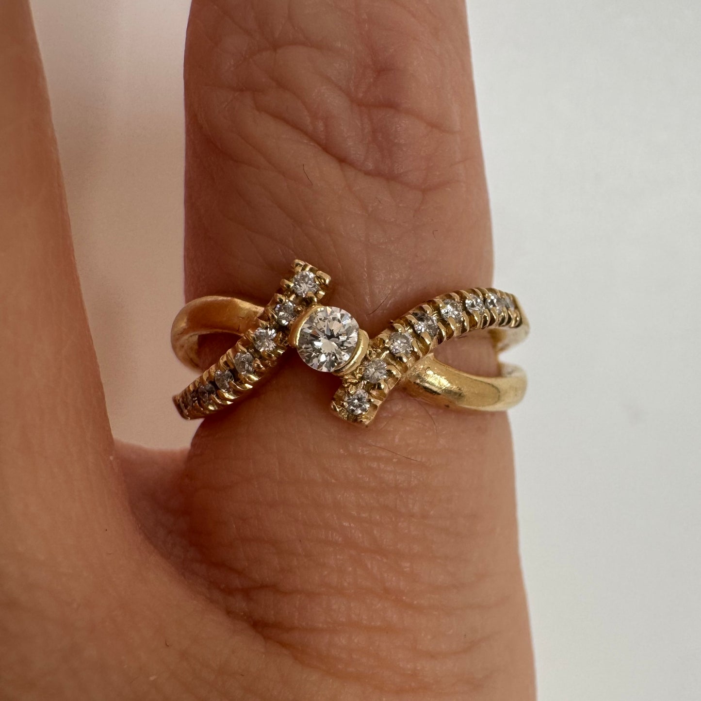 14K gold ring set with a central Diamond and sparkling side Diamonds