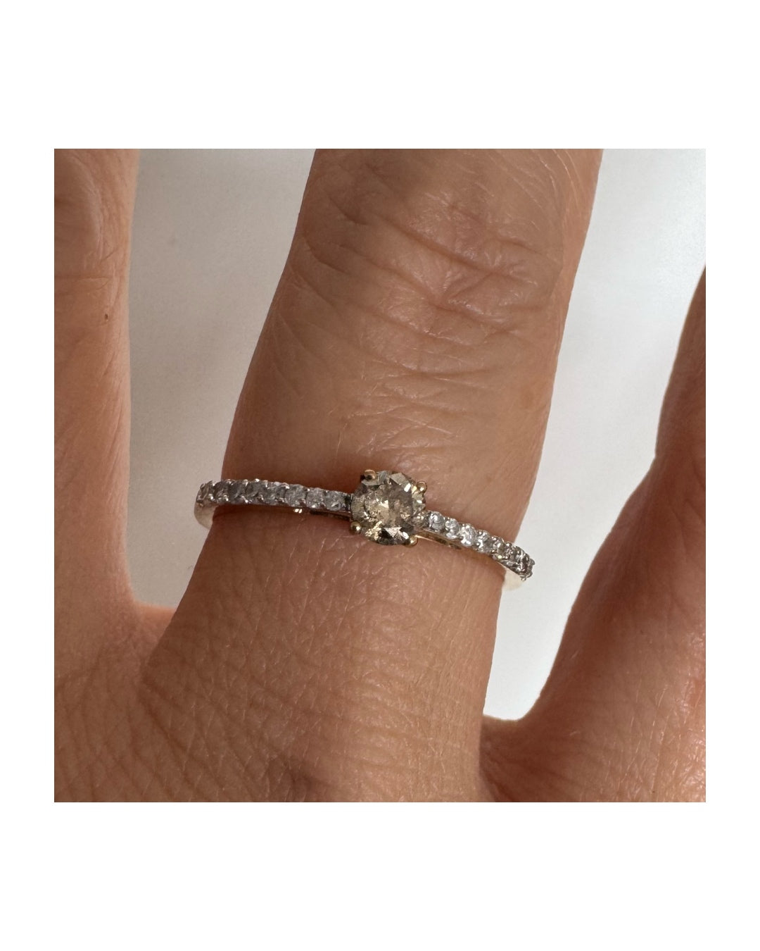 9K gold ring set with a central Diamond and sparkling Diamonds along the band