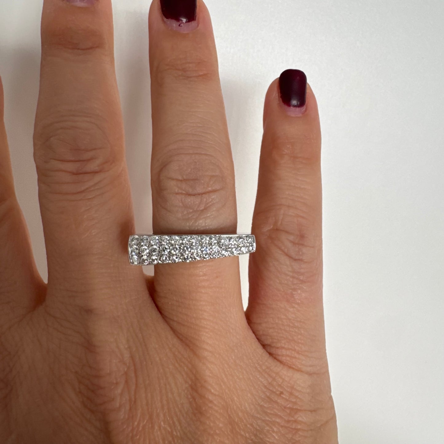 18K white gold band fully set with pavé diamonds across the surface.