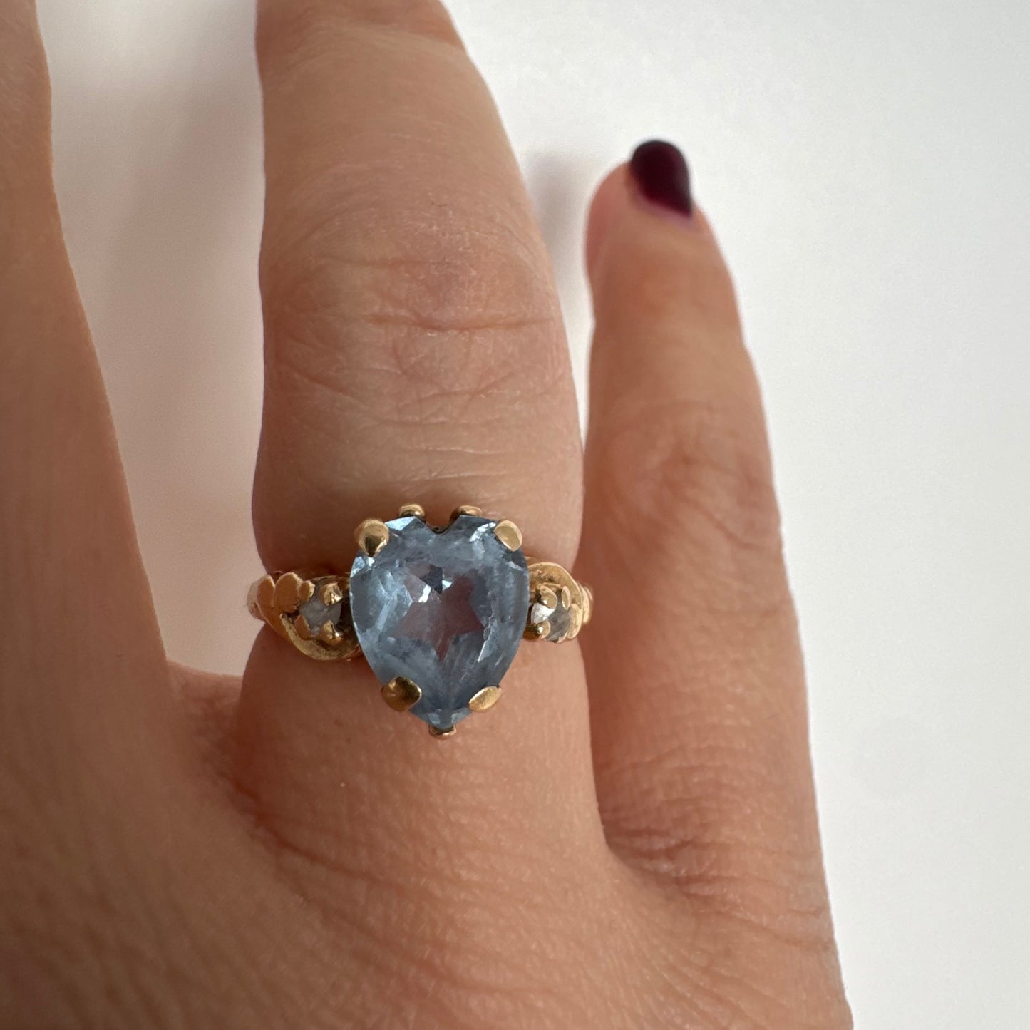 14K gold ring set with a heart-cut Blue Topaz stone