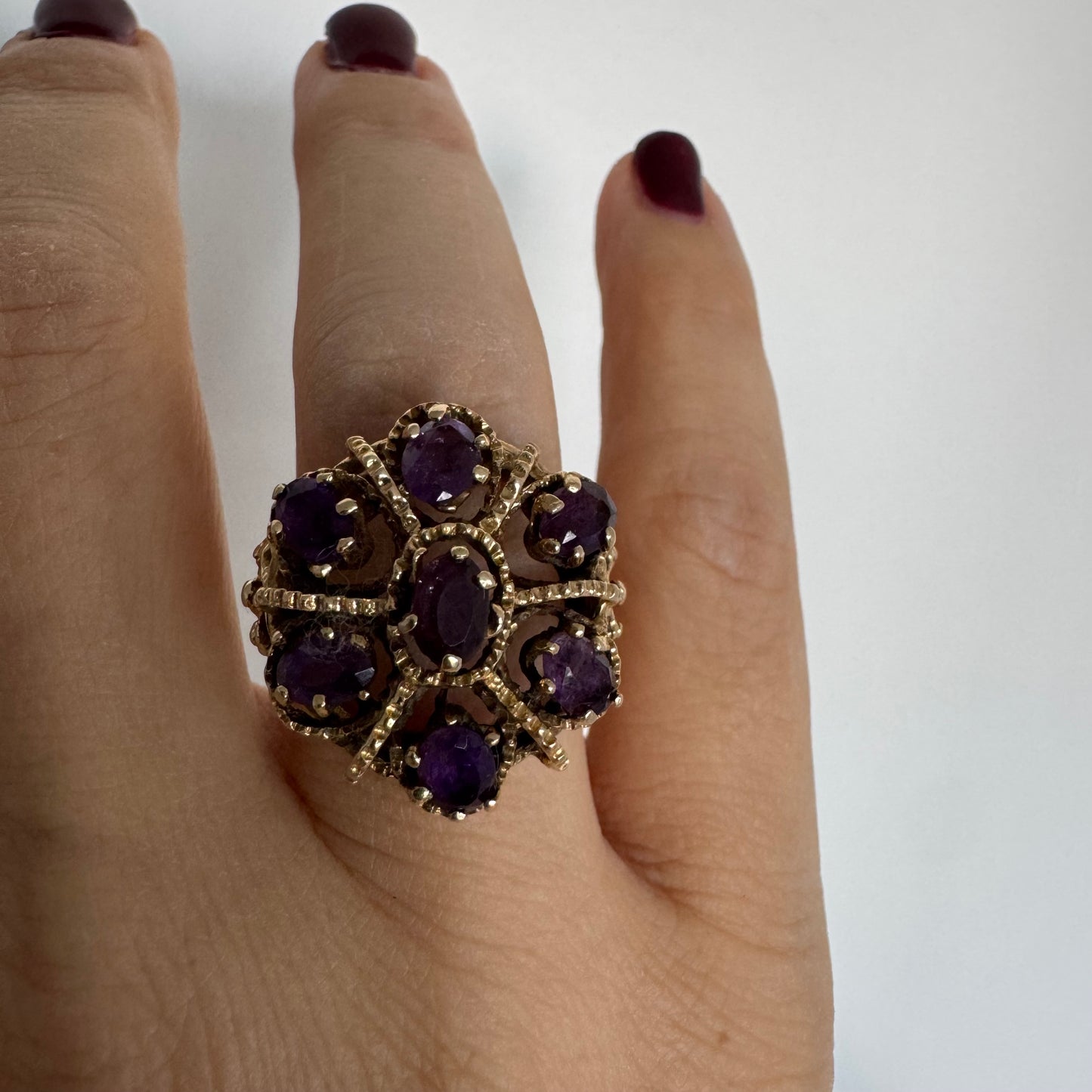 14K yellow gold cocktail ring set with a stunning cluster of Amethyst stones in marquise cuts.