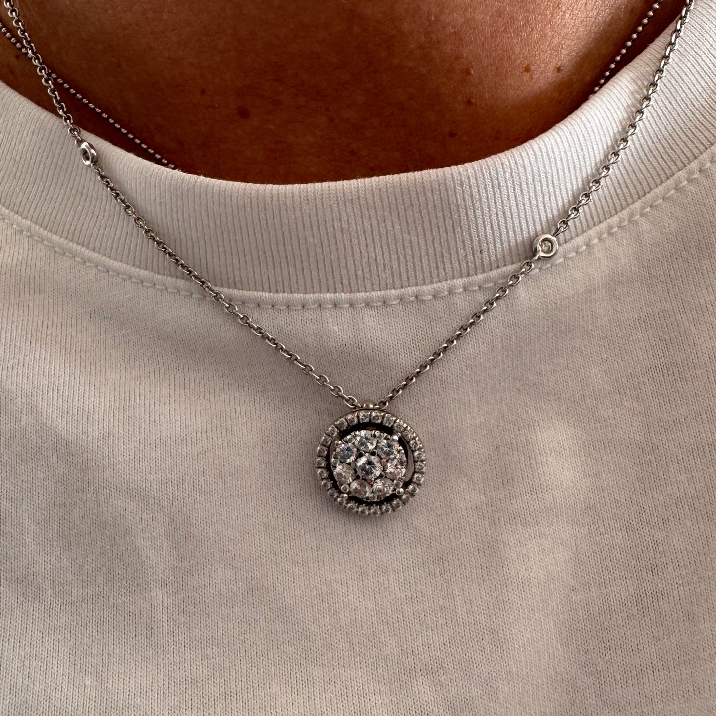 14K gold necklace featuring a round pendant set with a cluster of sparkling Diamonds