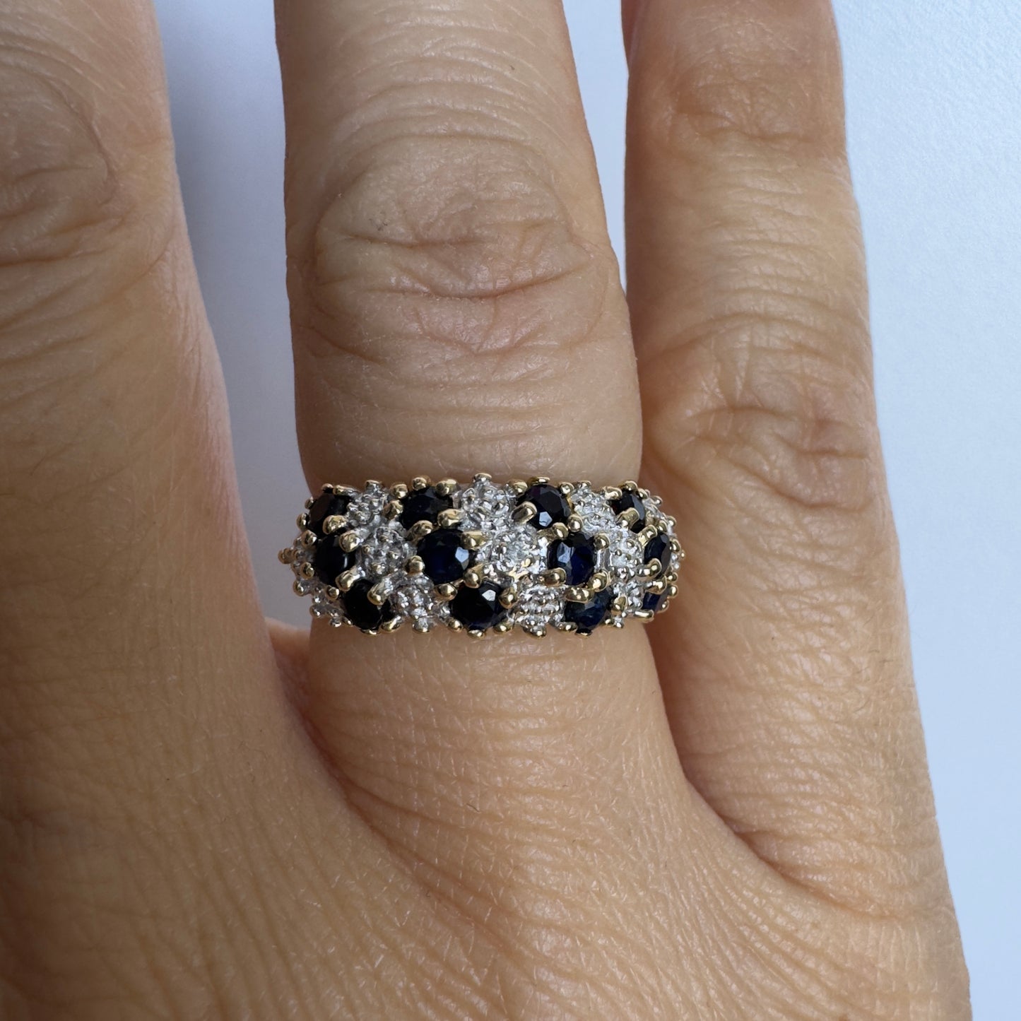 10K gold ring set with deep blue Sapphires and Diamonds in a classic, romantic design.