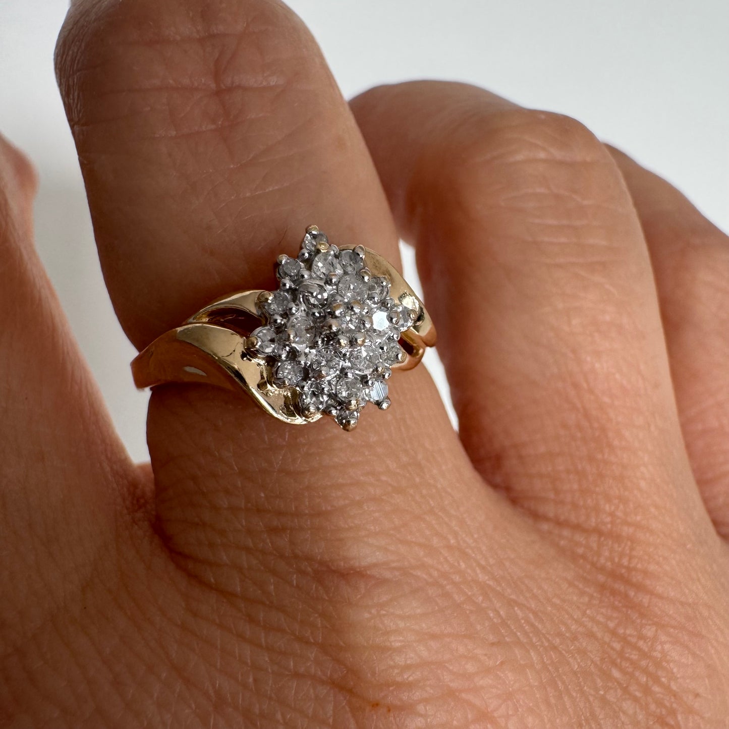 10K gold ring set with Diamonds, featuring a classic design with soft, flowing curves.