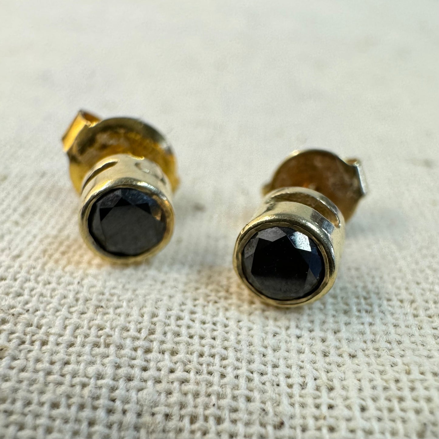 14K gold stud earrings set with Black Diamonds