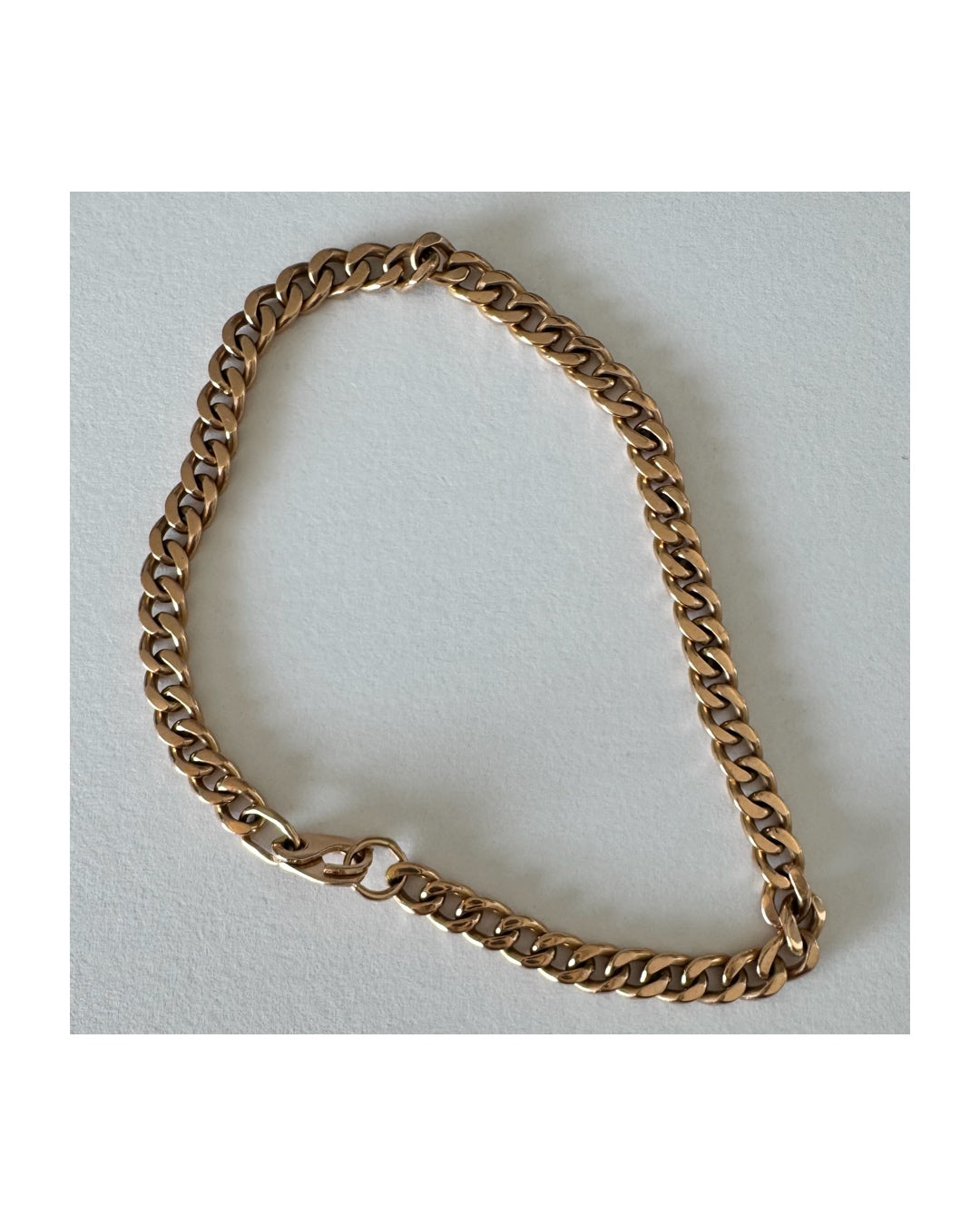 14K gold bracelet featuring a classic chain-link design with a sleek, elegant presence on the wrist.