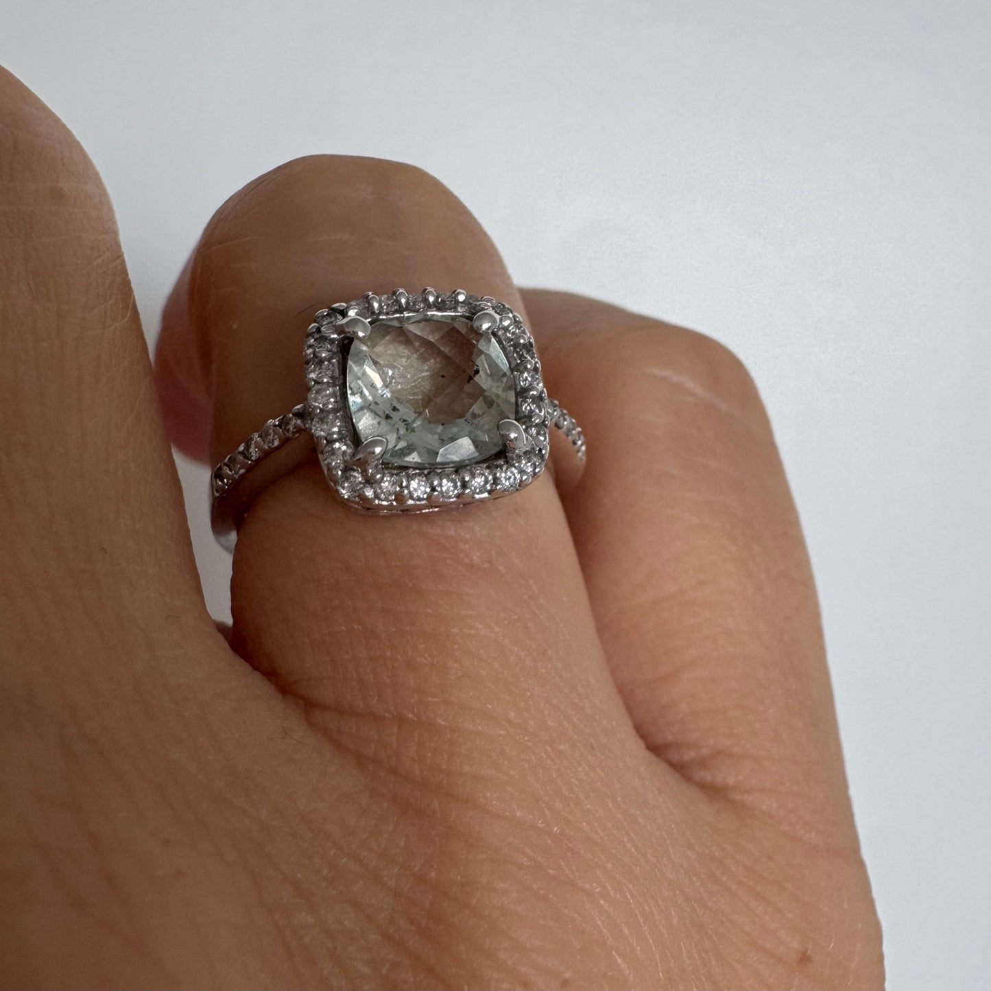 14K white gold ring featuring a cushion-cut light blue Aquamarine set in a sparkling double halo of round-cut Diamonds.