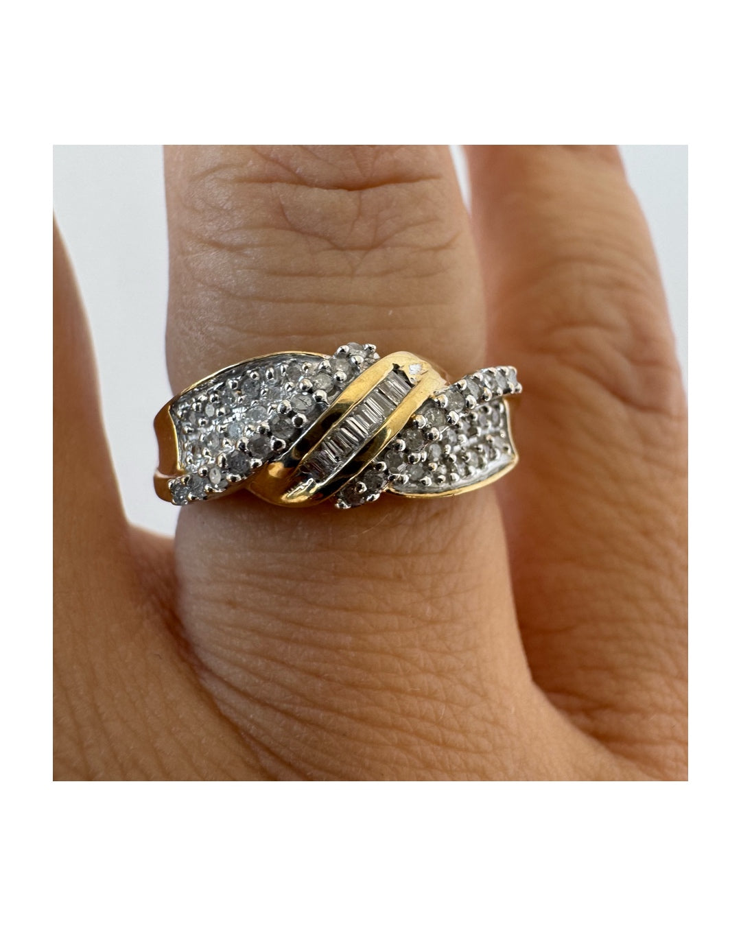 10K gold ring set with round-cut Diamonds and a central row of baguette Diamonds.