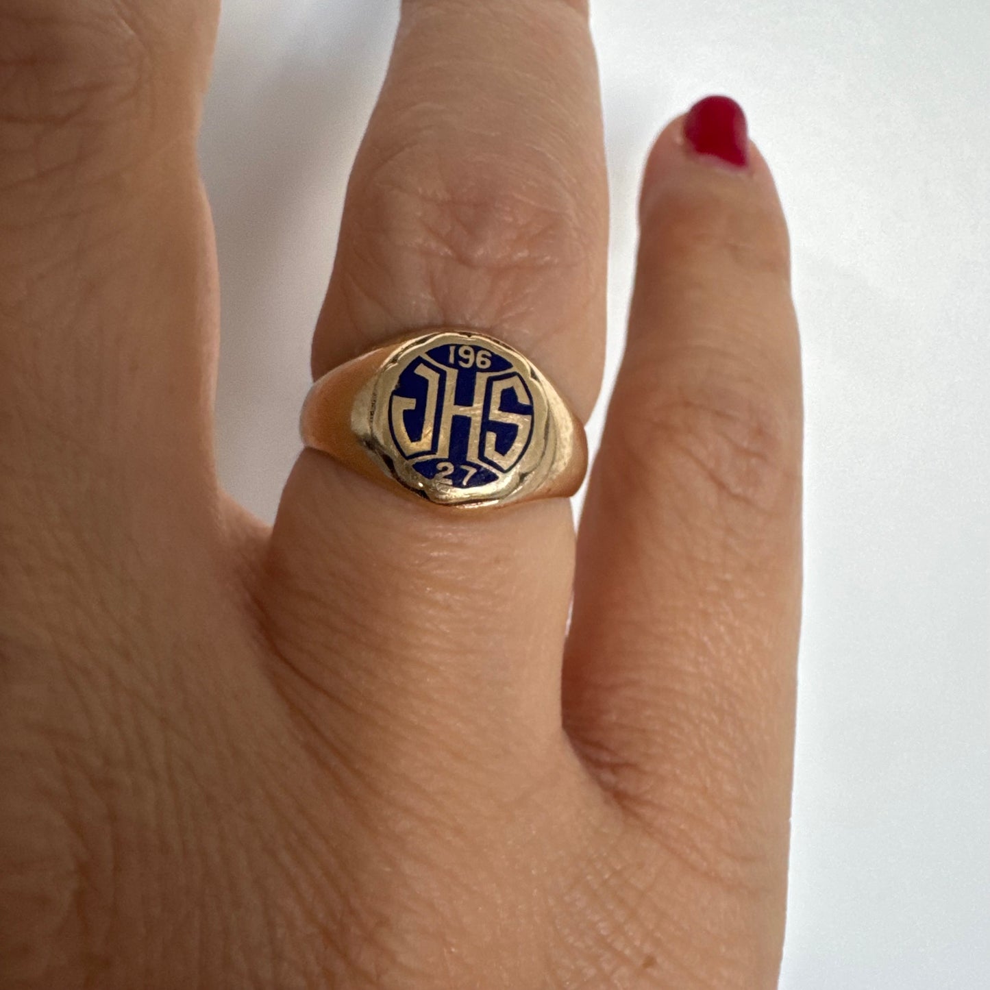 14K gold signet ring featuring an oval face with dark enamel and bold engraved initials at the center.