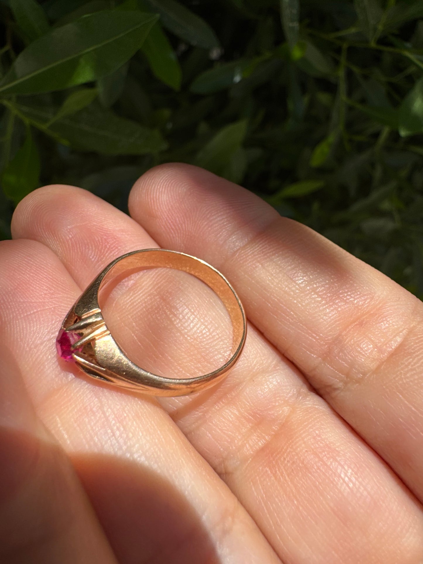 14K gold ring set with a vivid pink round-cut Ruby