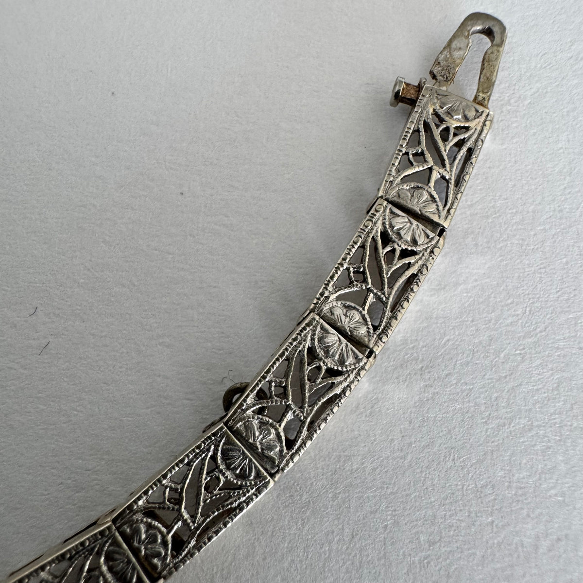 14K gold bracelet featuring intricate openwork and beautifully engraved details set with Sapphire & Diamonds