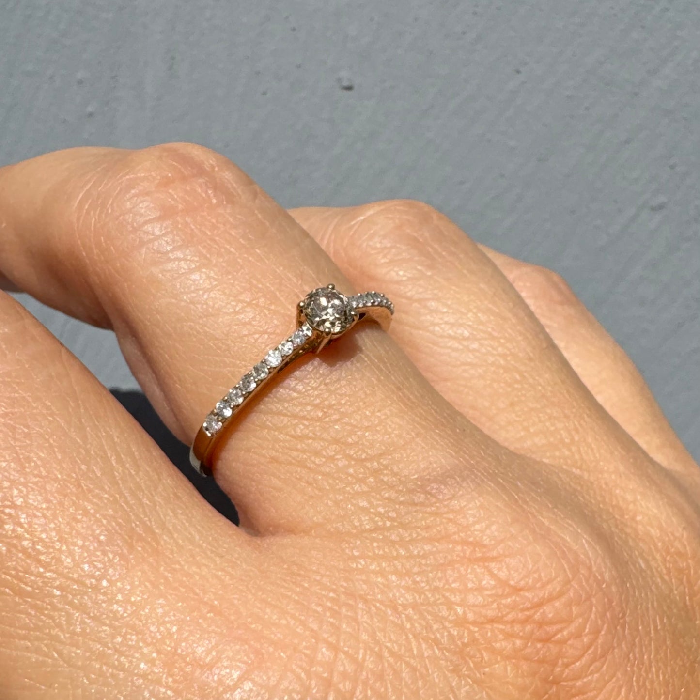 9K gold ring set with a central Diamond and sparkling Diamonds along the band