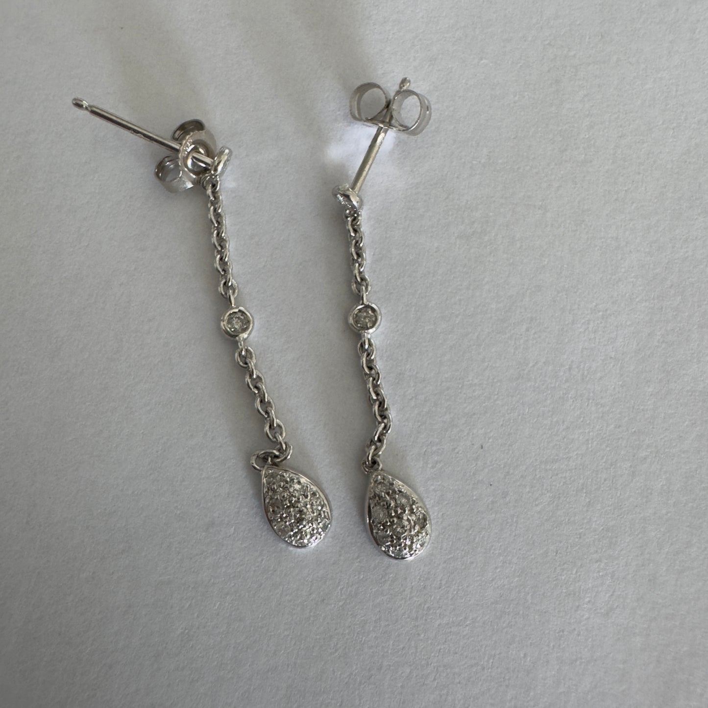 14K gold drop earrings featuring a delicate chain design with sparkling teardrop pendants.