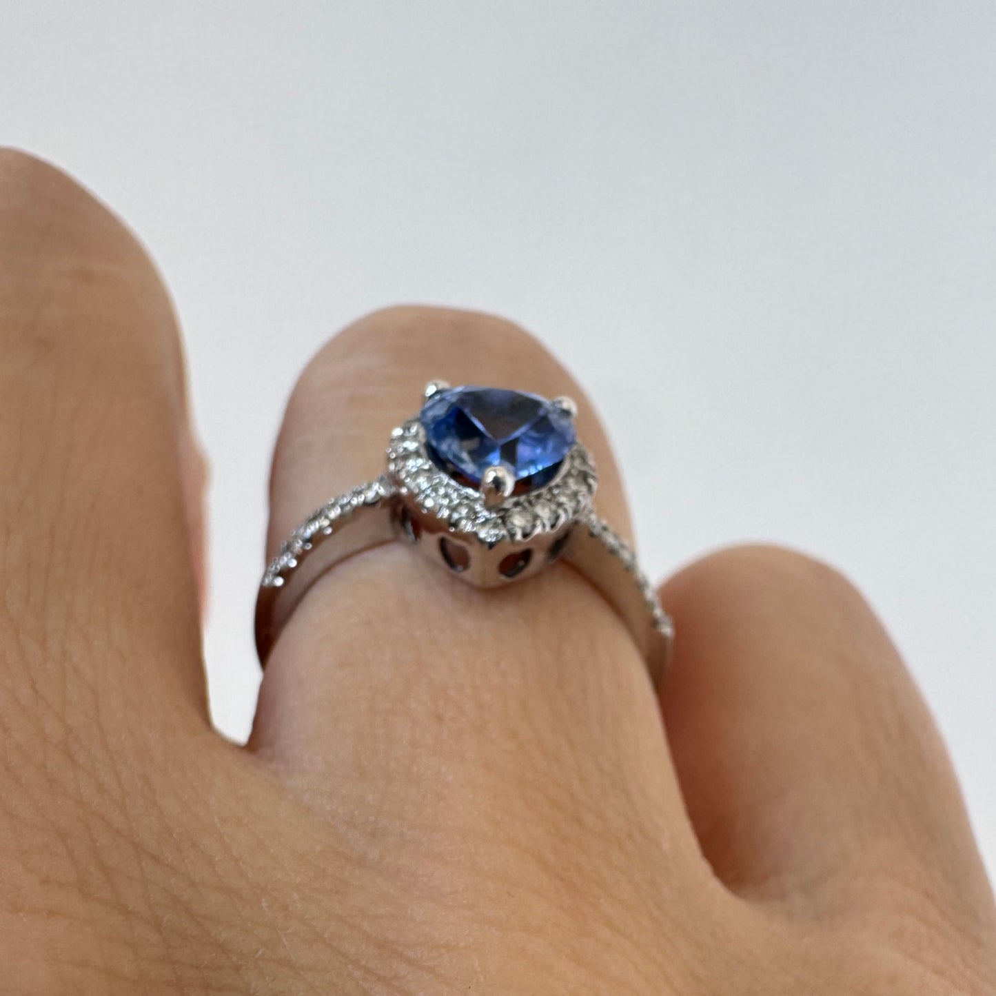14K gold ring set with a heart-cut Tanzanite surrounded by a halo of Diamonds