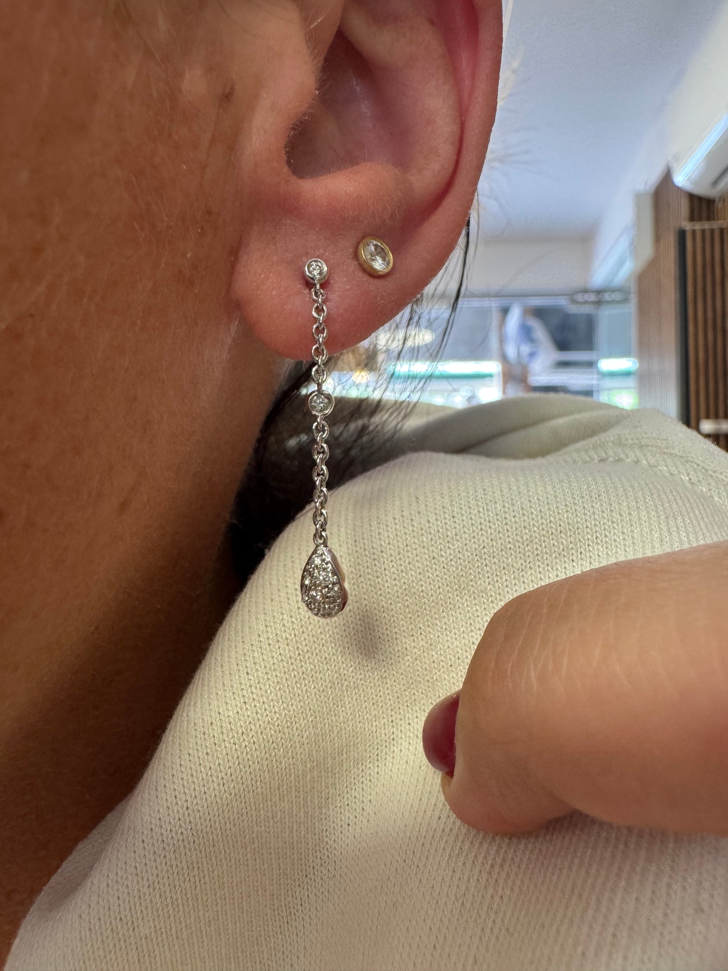 14K gold drop earrings featuring a delicate chain design with sparkling teardrop pendants.