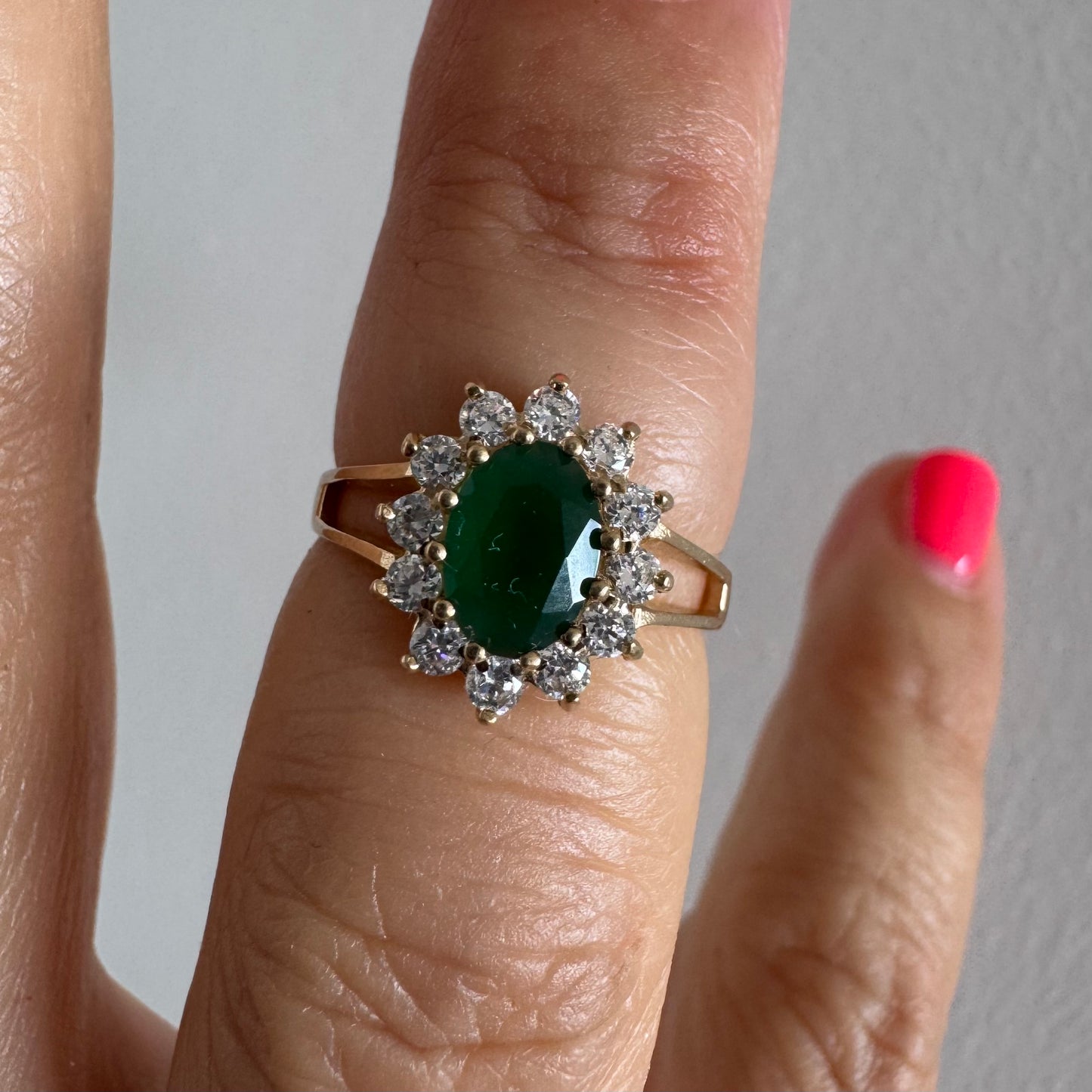 9K gold ring set with a striking green Emerald in a timeless classic design.