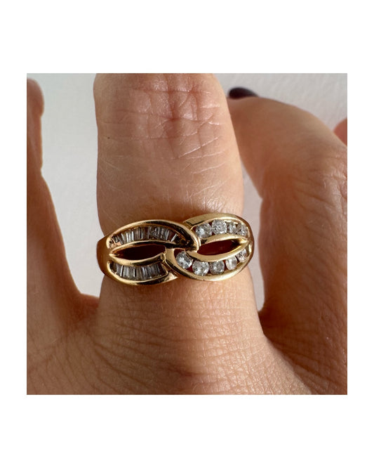 14K gold open infinity ring set with round and baguette-cut Diamonds.