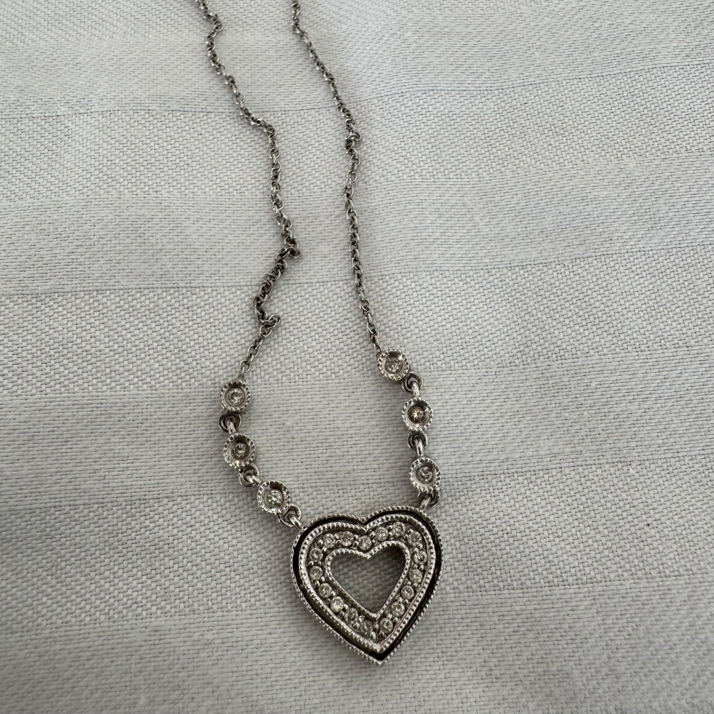 שרשרת זהב לבן 14 קראט משובצת יהלומים, בעיצוב לב עדין ומלא רומנטיקה.