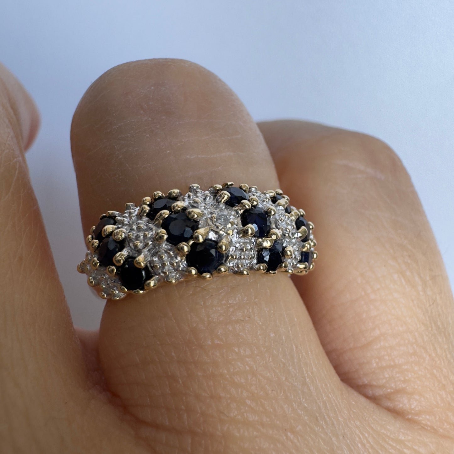 10K gold ring set with deep blue Sapphires and Diamonds in a classic, romantic design.