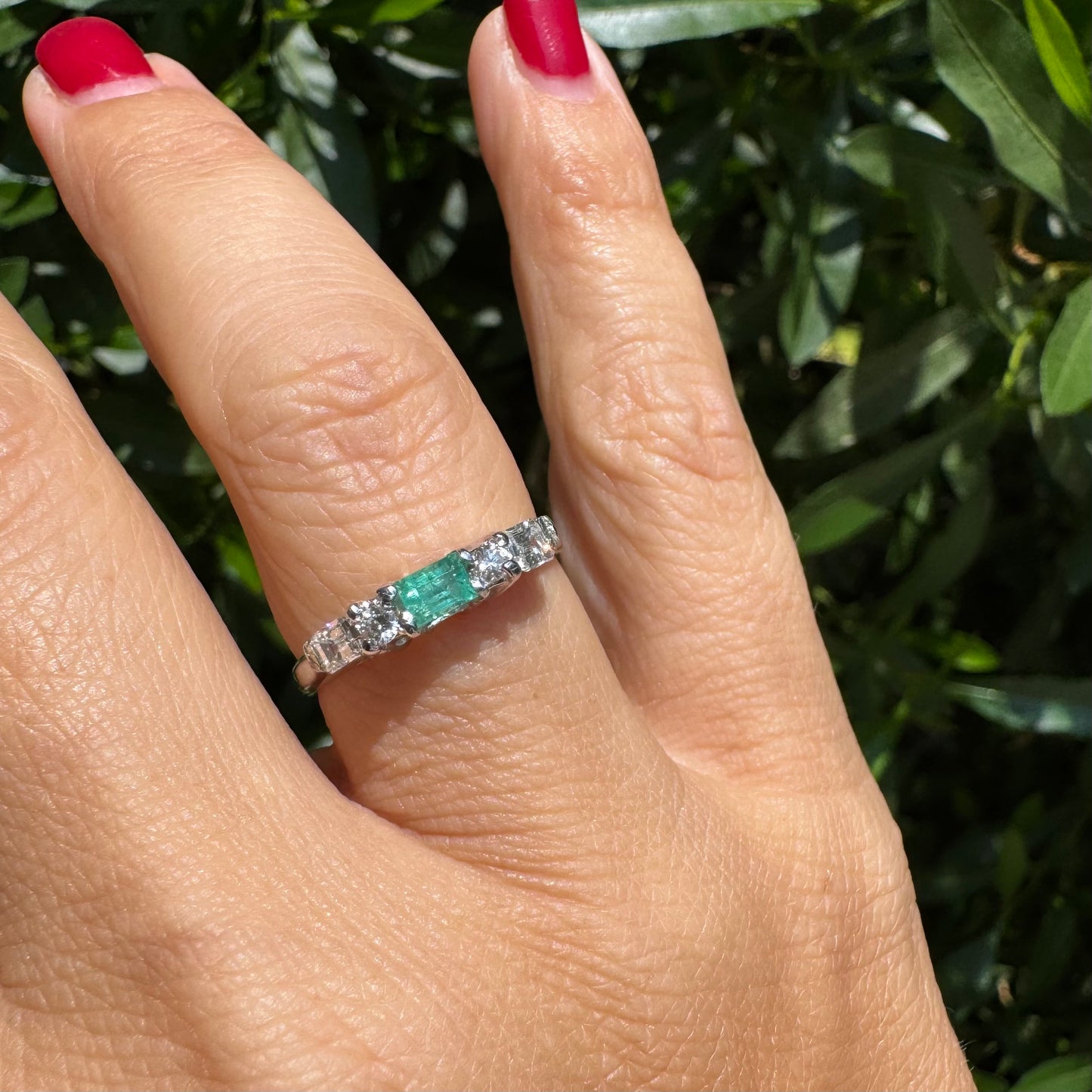 14K gold ring set with one center Emerald & Diamonds on the sides
