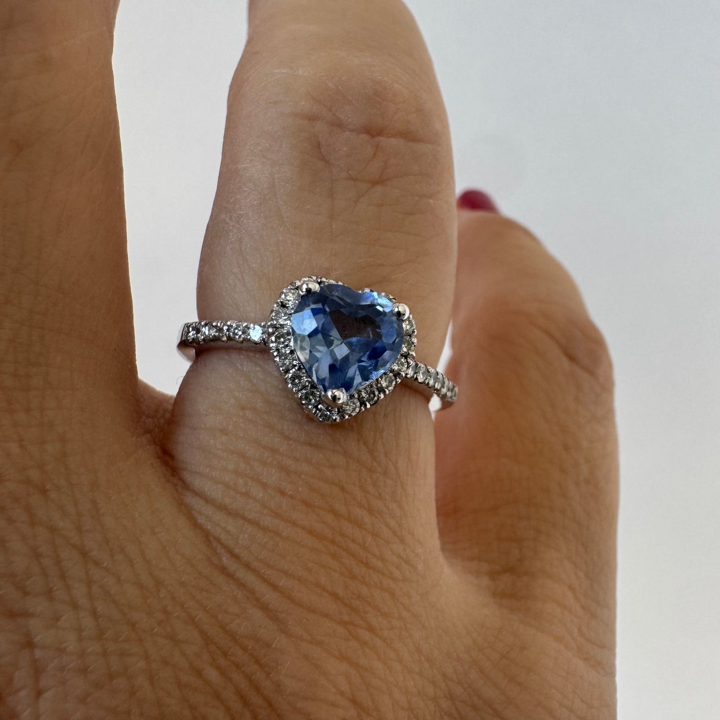 14K gold ring set with a heart-cut Tanzanite surrounded by a halo of Diamonds