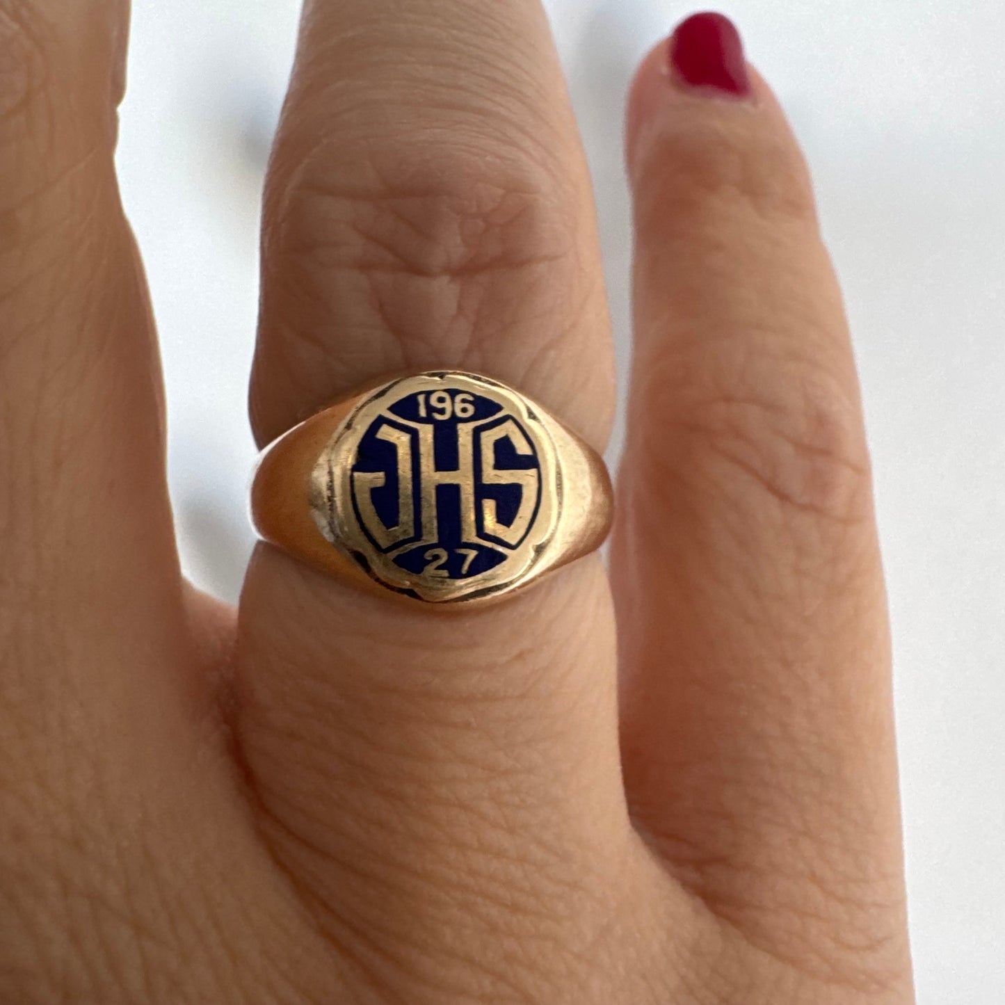 14K gold signet ring featuring an oval face with dark enamel and bold engraved initials at the center.