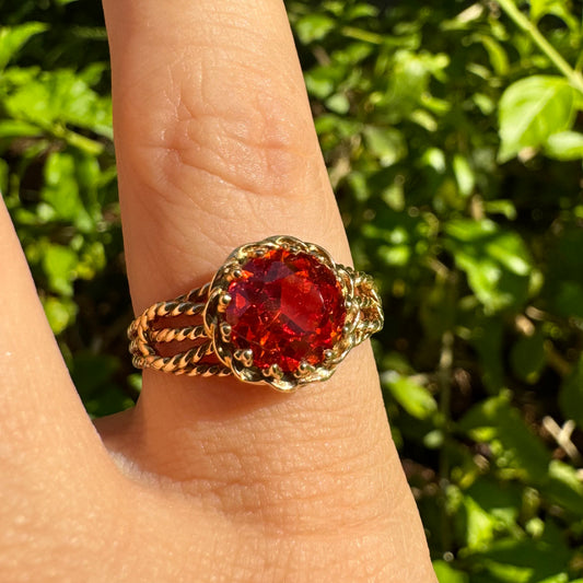 10K gold ring set with a vivid orange gemstone