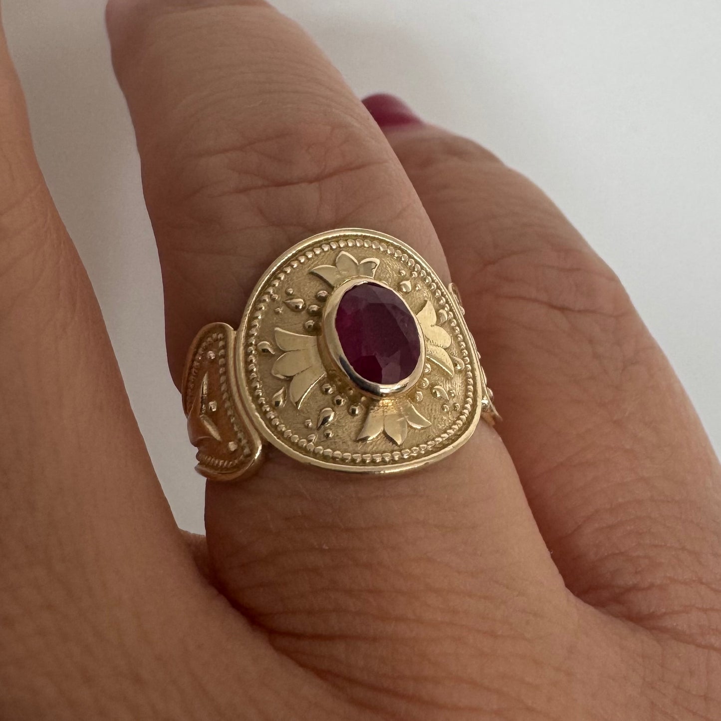 14K gold ring set with an oval Ruby