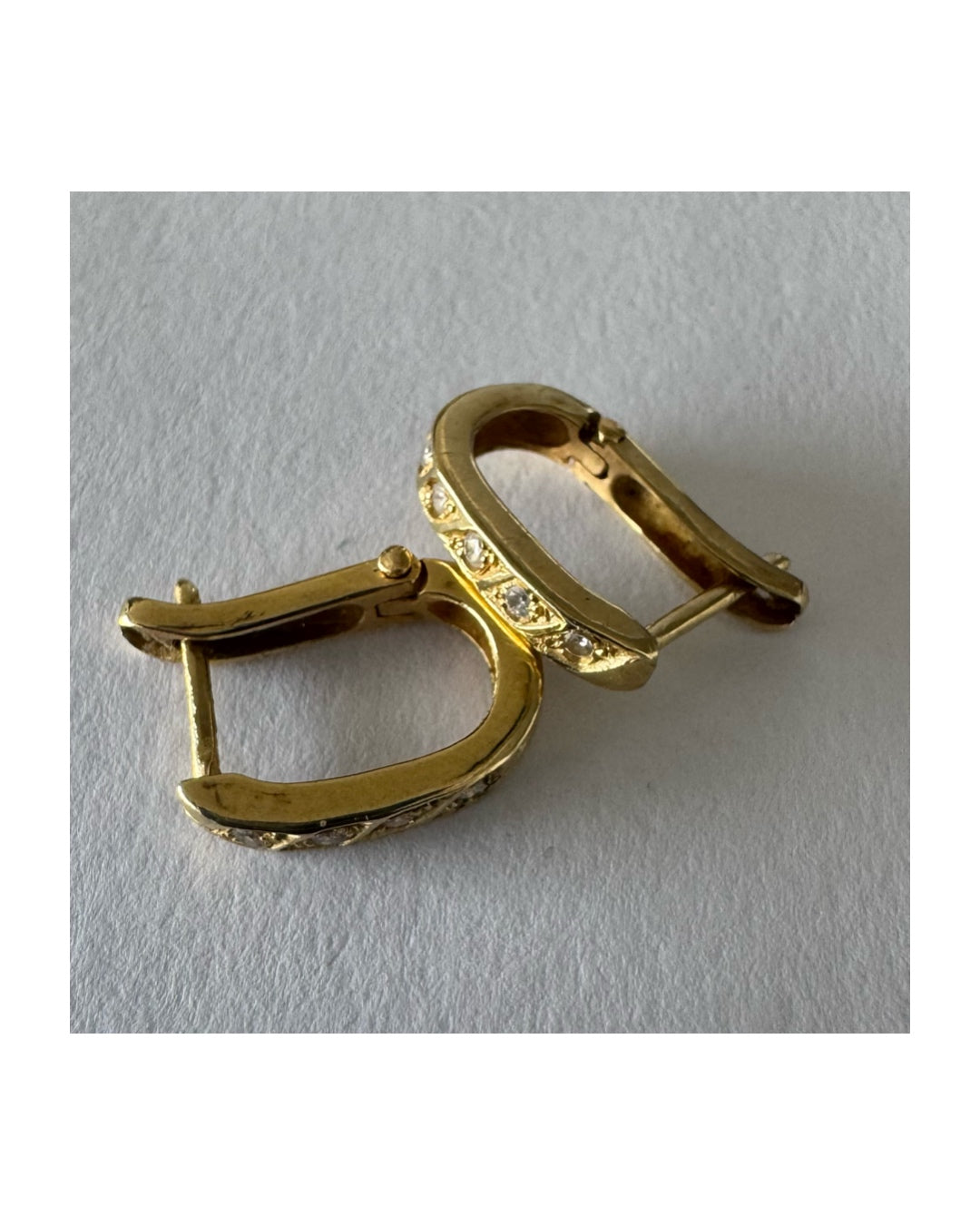 14K gold huggie earrings accented with a delicate row of sparkling Diamonds