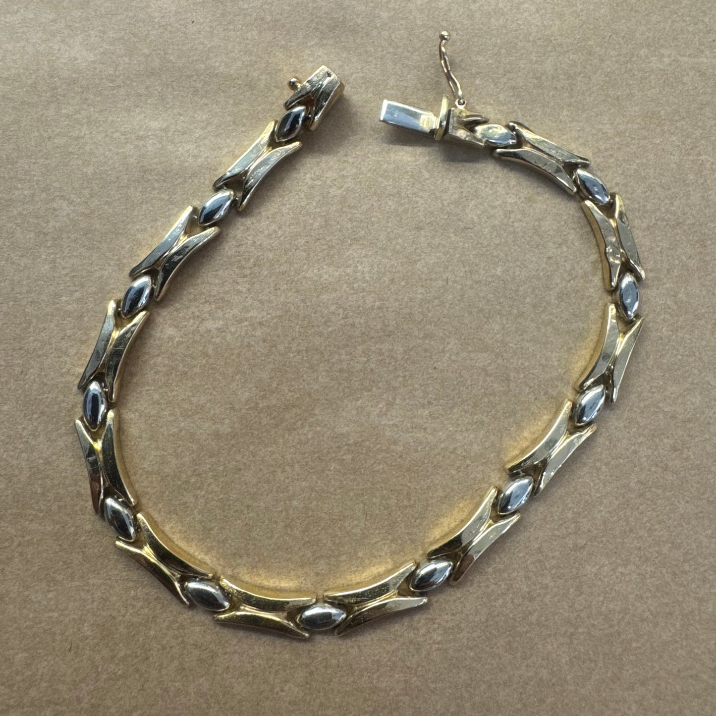 14K gold bracelet featuring a bold geometric design with X-shaped