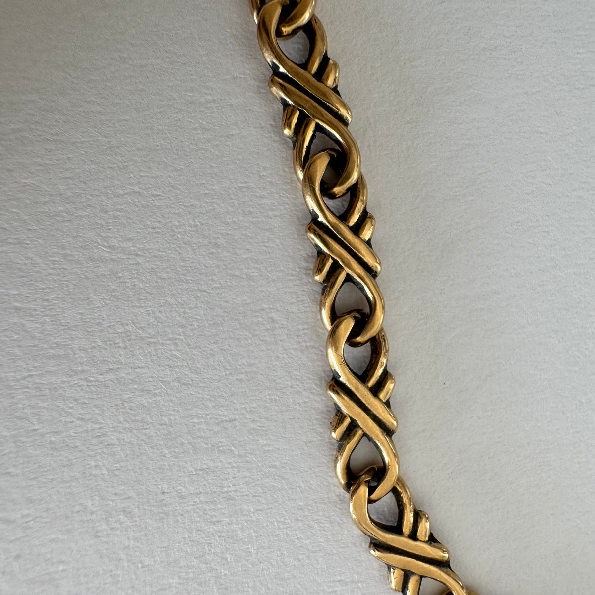 14K gold bracelet with a delicate twisted-link design.
