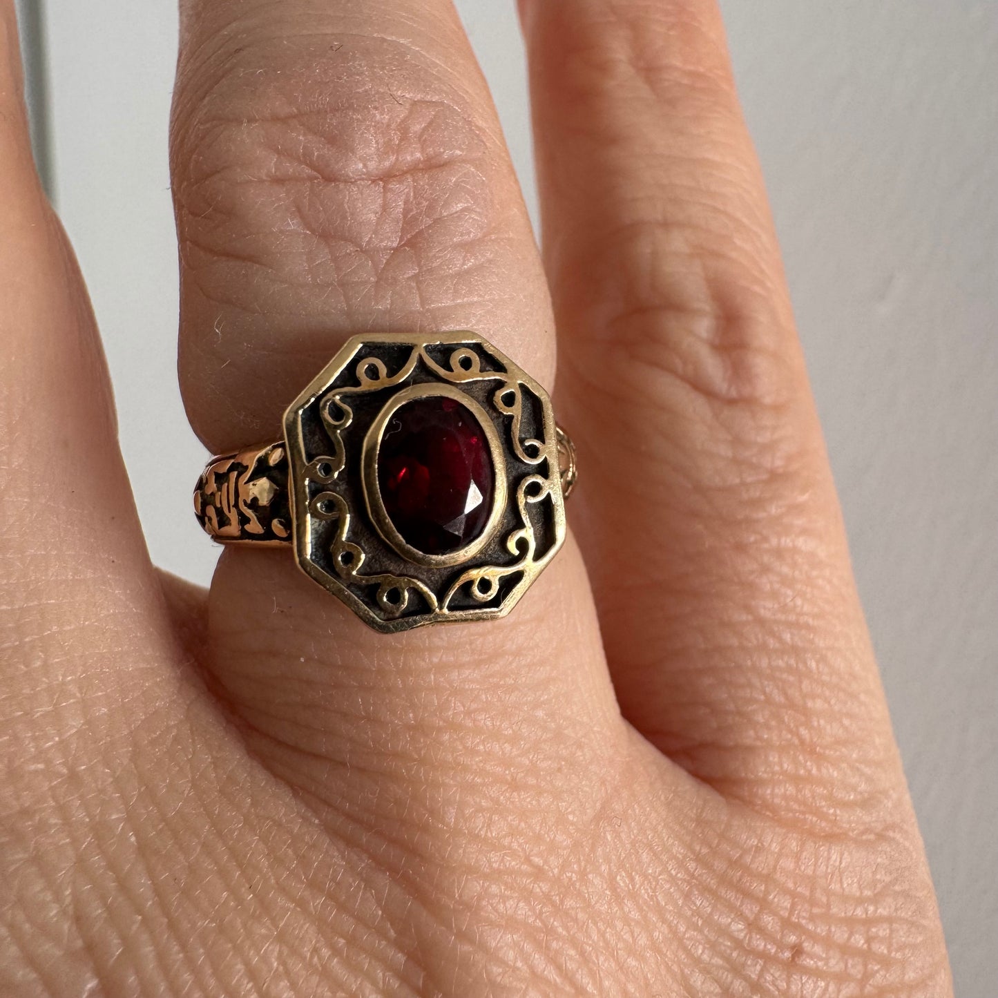14K gold ring set with an oval deep-red Garnet.