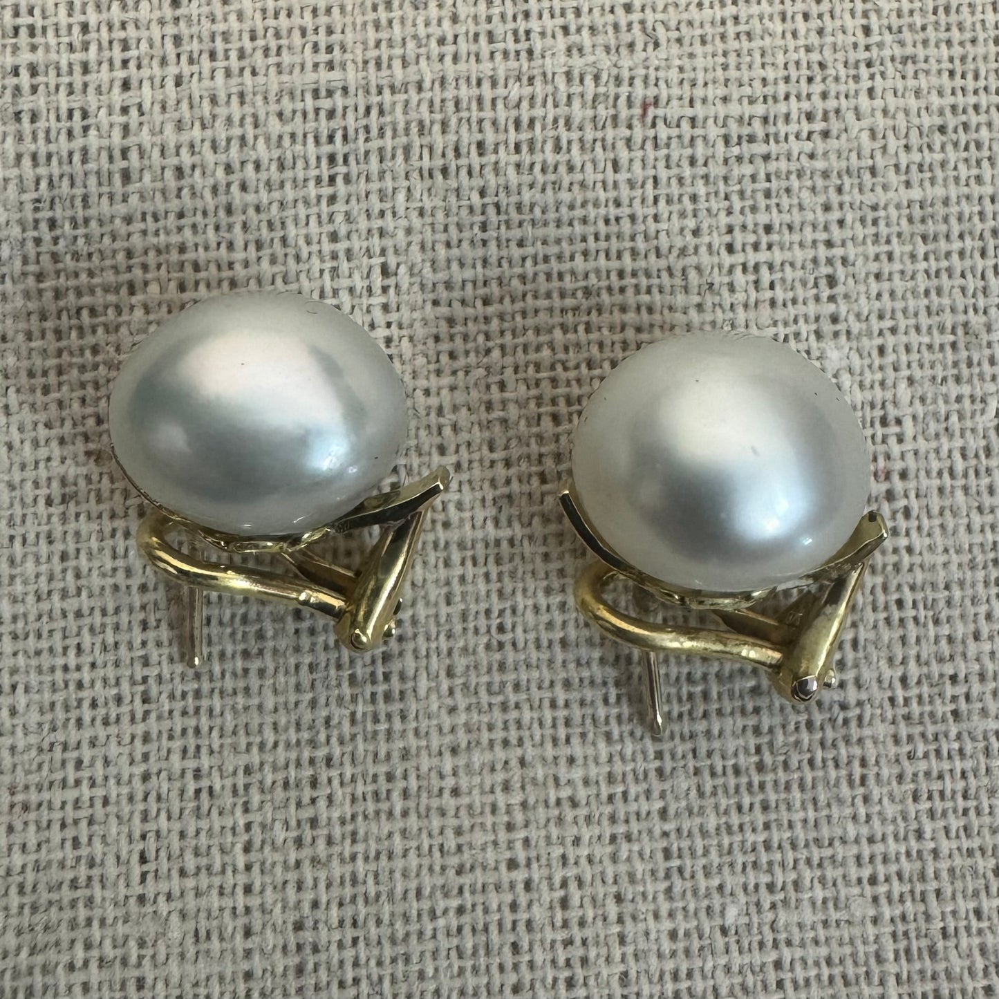 14K gold stud earrings set with large & luminous white Pearls.