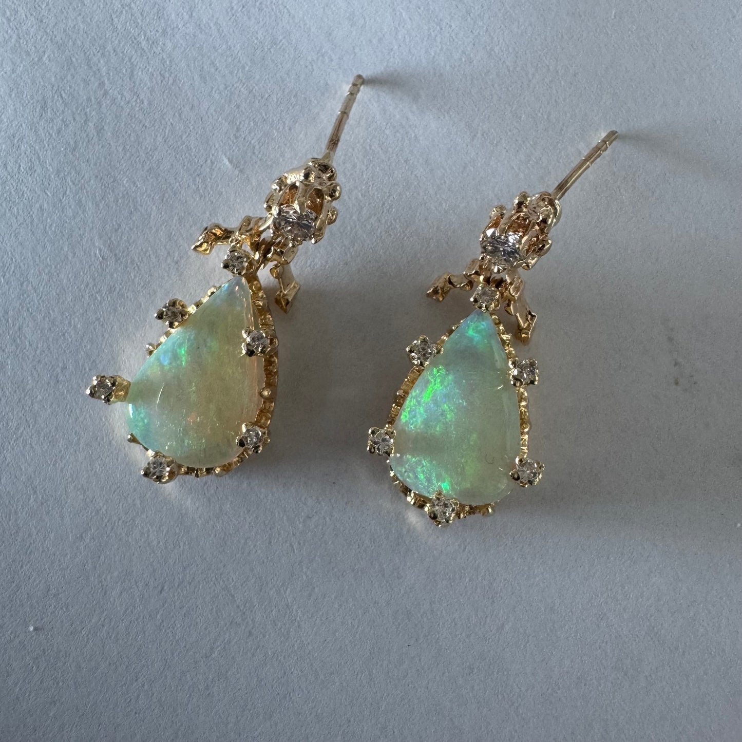 14K gold drop earrings set with pear-shaped Opals and Diamonds.