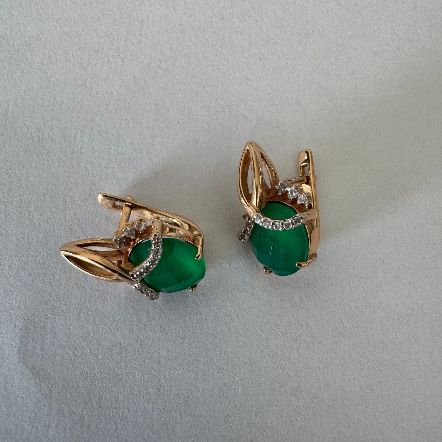14K gold earrings set with vibrant green stones