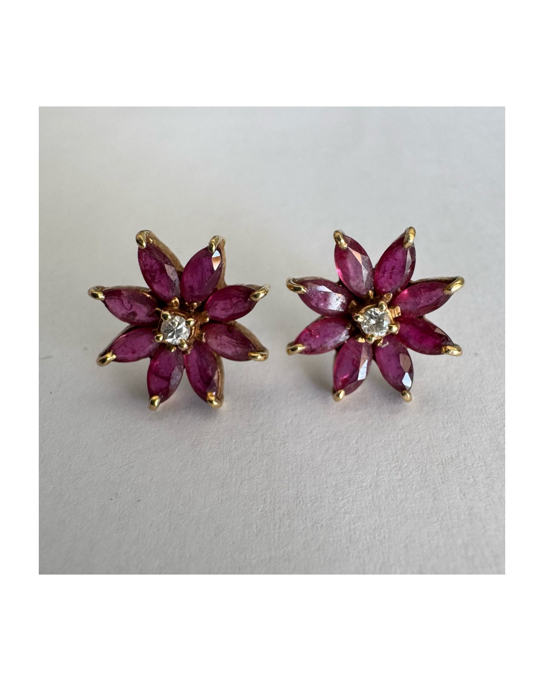 14K gold floral earrings set with marquise-cut Rubies and a small Diamond at the center