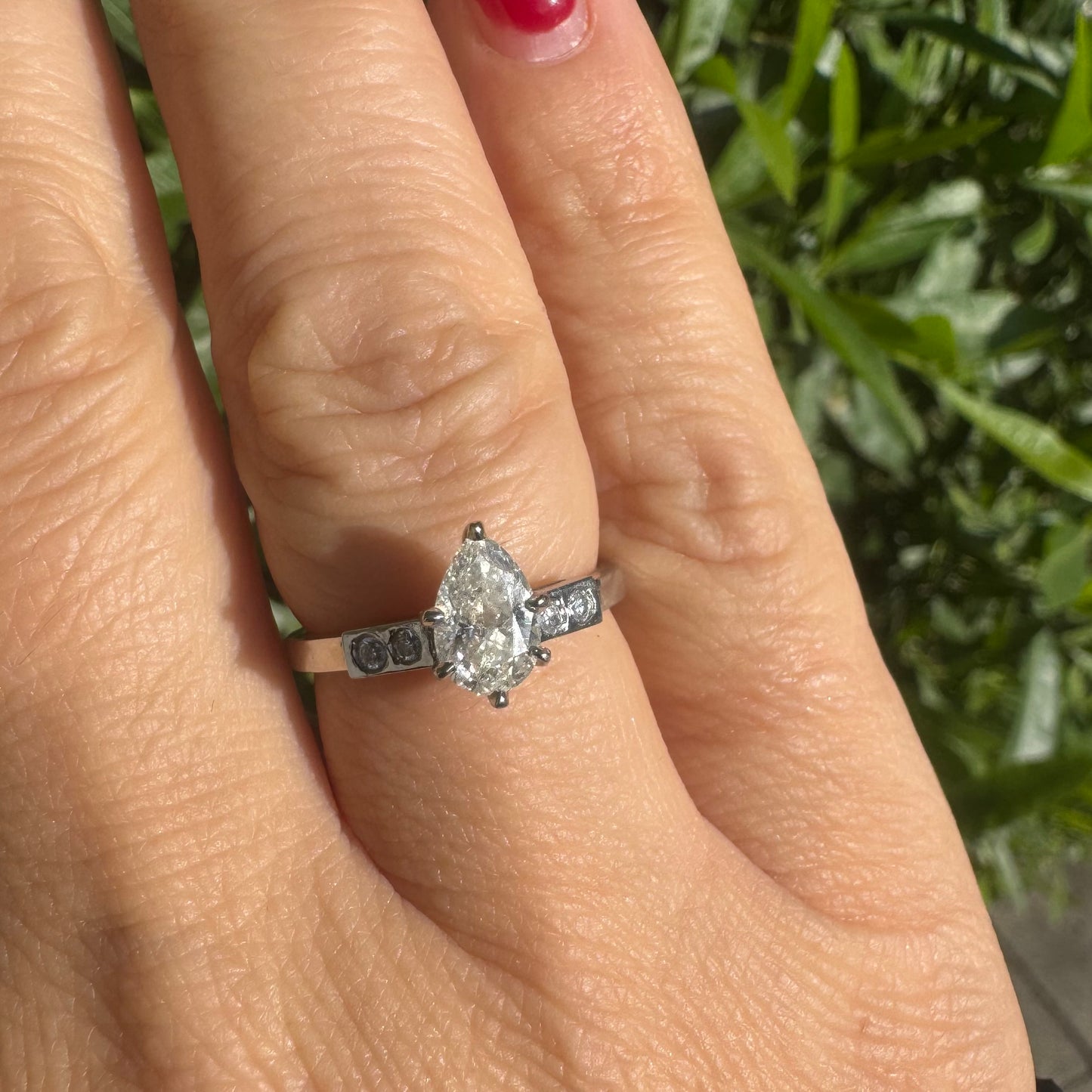 Platinum ring set with one center Pear cut Diamond & side Diamonds