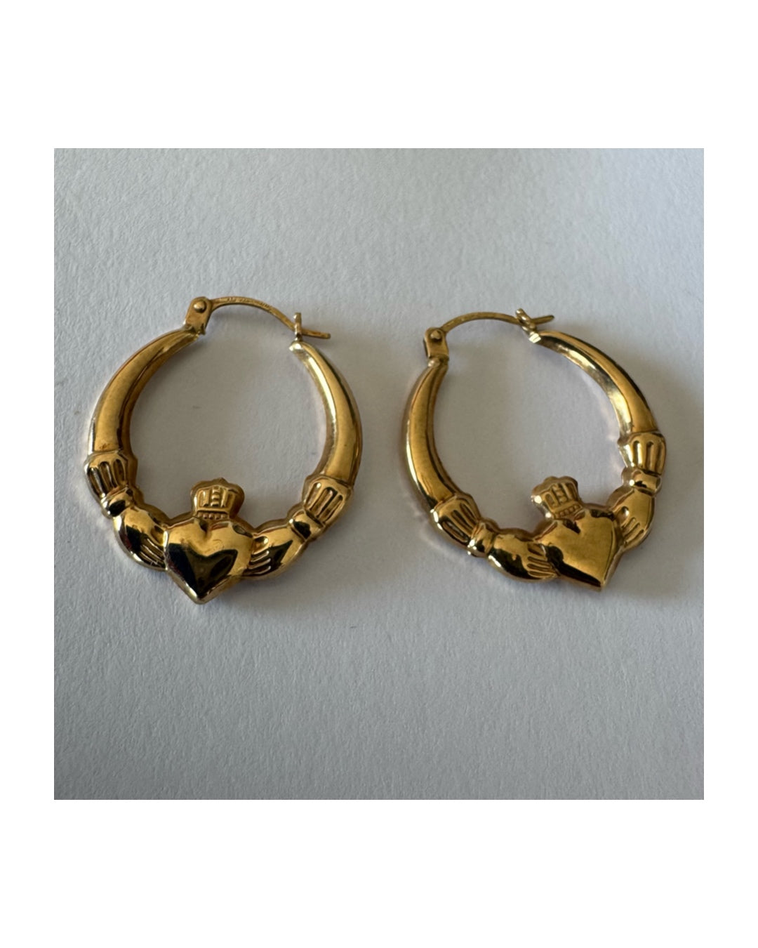 9K gold Claddagh earrings, featuring the iconic Irish motif of a heart held by two hands and topped with a crown, traditionally symbolizing love, friendship and loyalty.